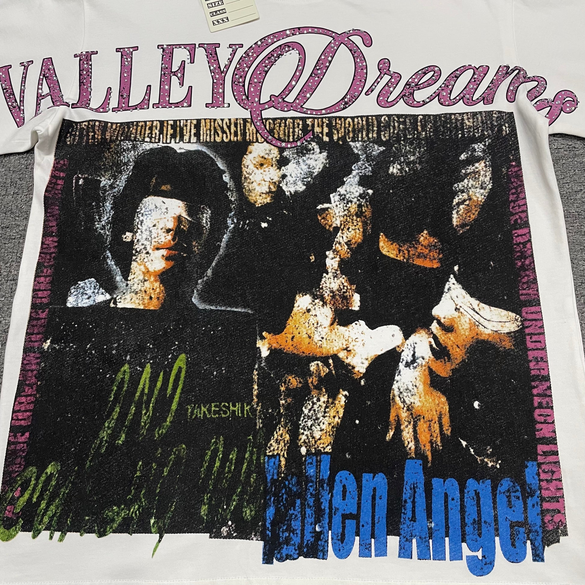 Vale Forever Fallen Bling Tee full Fallen Angel front graphic
Vale Forever Fallen Bling Tee distressed Fallen Angel collage artwork
Vale Forever Fallen Bling Tee distressed portrait collage print detail
Vale Forever Fallen Bling Tee pink Valley Dreams rhinestone lettering
Vale Forever Fallen Bling Tee sparkling rhinestone embellishment close-up
Vale Forever Fallen Bling Tee blue Fallen Angel lettering detail
Vale Forever Fallen Bling Tee multicolor distressed graphic detail
