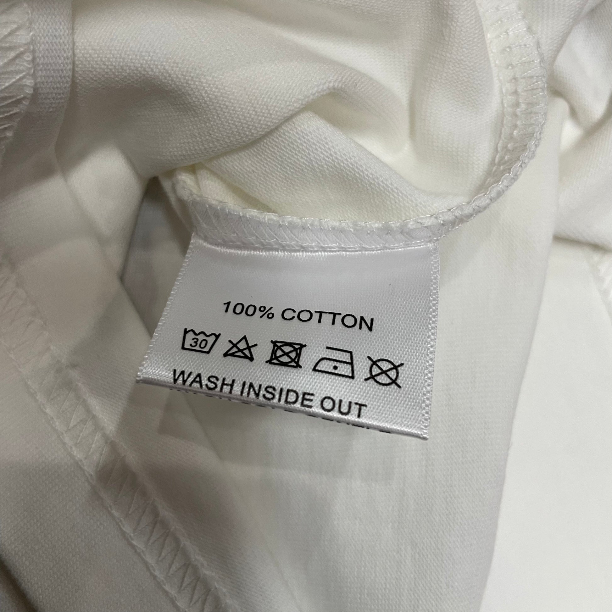 Vale Forever Dreams Tour Tee double stitched bottom hem detail
Vale Forever Dreams Tour Tee wash care label close-up