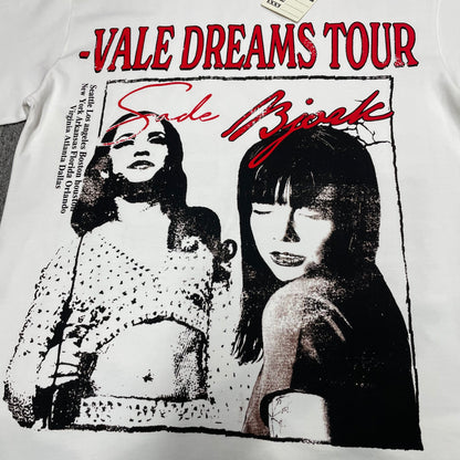 Vale Forever Dreams Tour Tee full Sade and Bjork front graphic
Vale Forever Dreams Tour Tee Sade and Bjork portrait graphic
Sade and Bjork black and white portrait print detail on cream tee
Vale Dreams Tour distressed red lettering print close-up
Sade Bjork red script lettering detail on Vale Forever graphic tee
Vale Forever Dreams Tour Tee distressed vintage front print detail