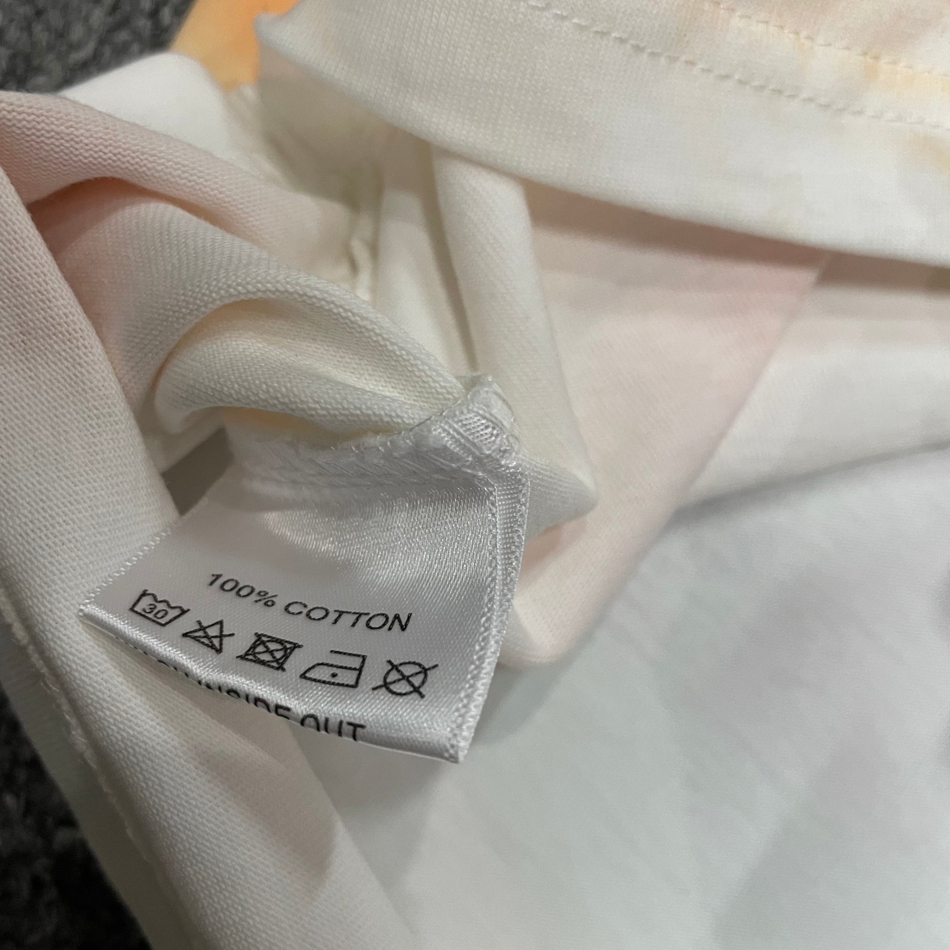 Vale Forever Target Tee double stitched bottom hem detail
Vale Forever Target Tee wash care label close-up