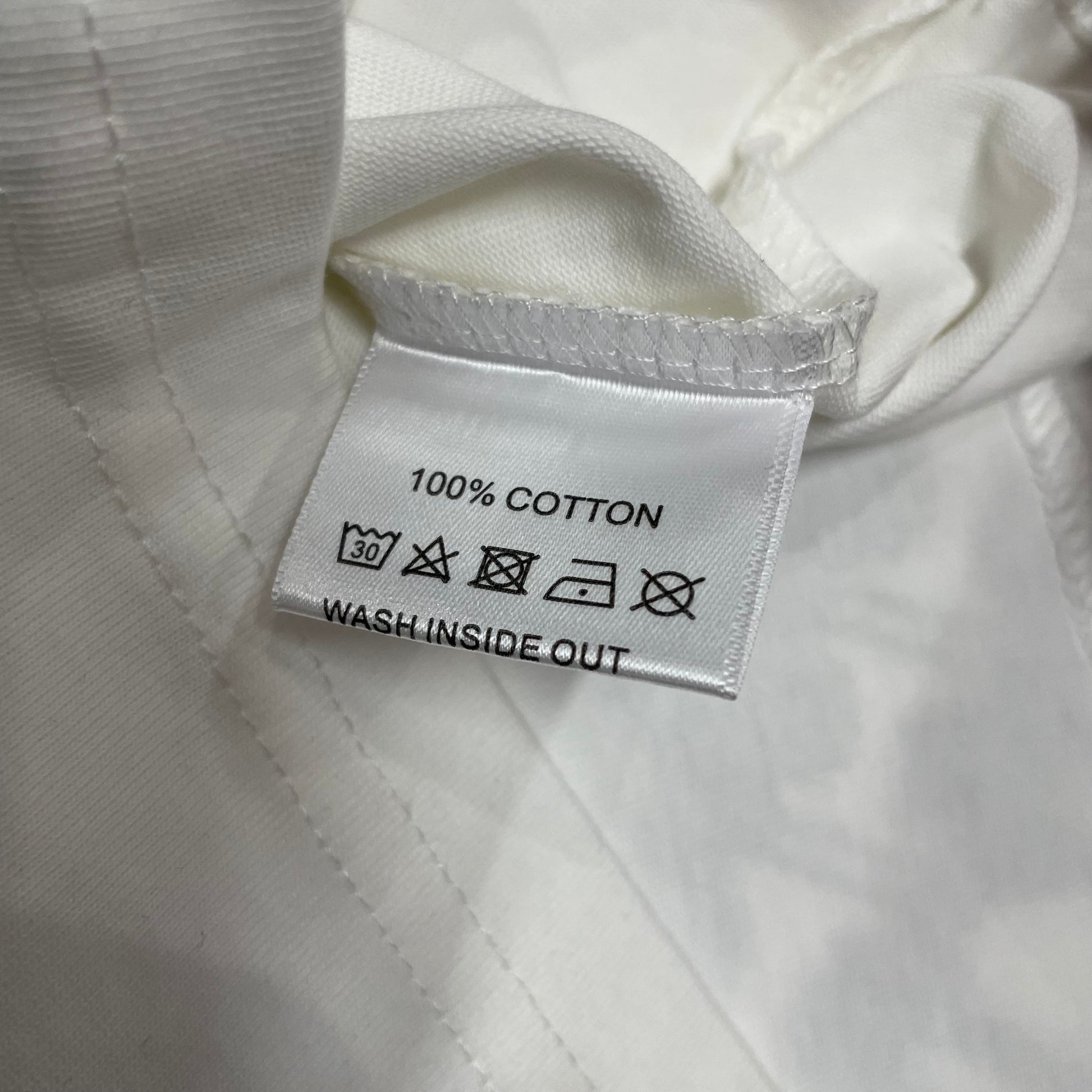 Vale Forever Scissorhands Tee double stitched bottom hem detail
Vale Forever Scissorhands Tee wash care label close-up