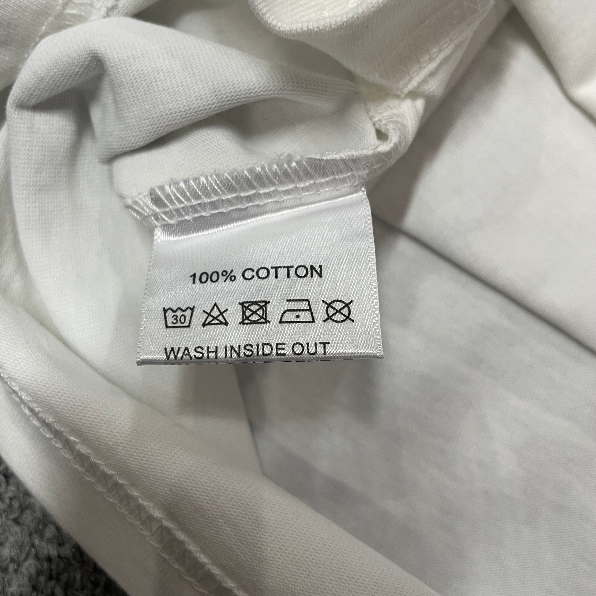 Vale Forever Godfather Bling Tee double stitched bottom hem detail
Vale Forever Godfather Bling Tee wash care label close-up