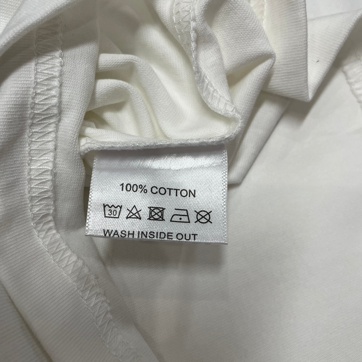 Vale Forever Destroyer King Tee double stitched bottom hem detail
Vale Forever Destroyer King Tee wash care label close-up