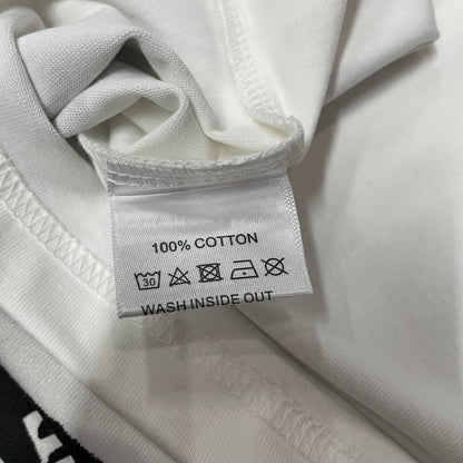 Vale Forever Thunder Cross Bling Tee double stitched bottom hem detail
Vale Forever Thunder Cross Bling Tee wash care label close-up
