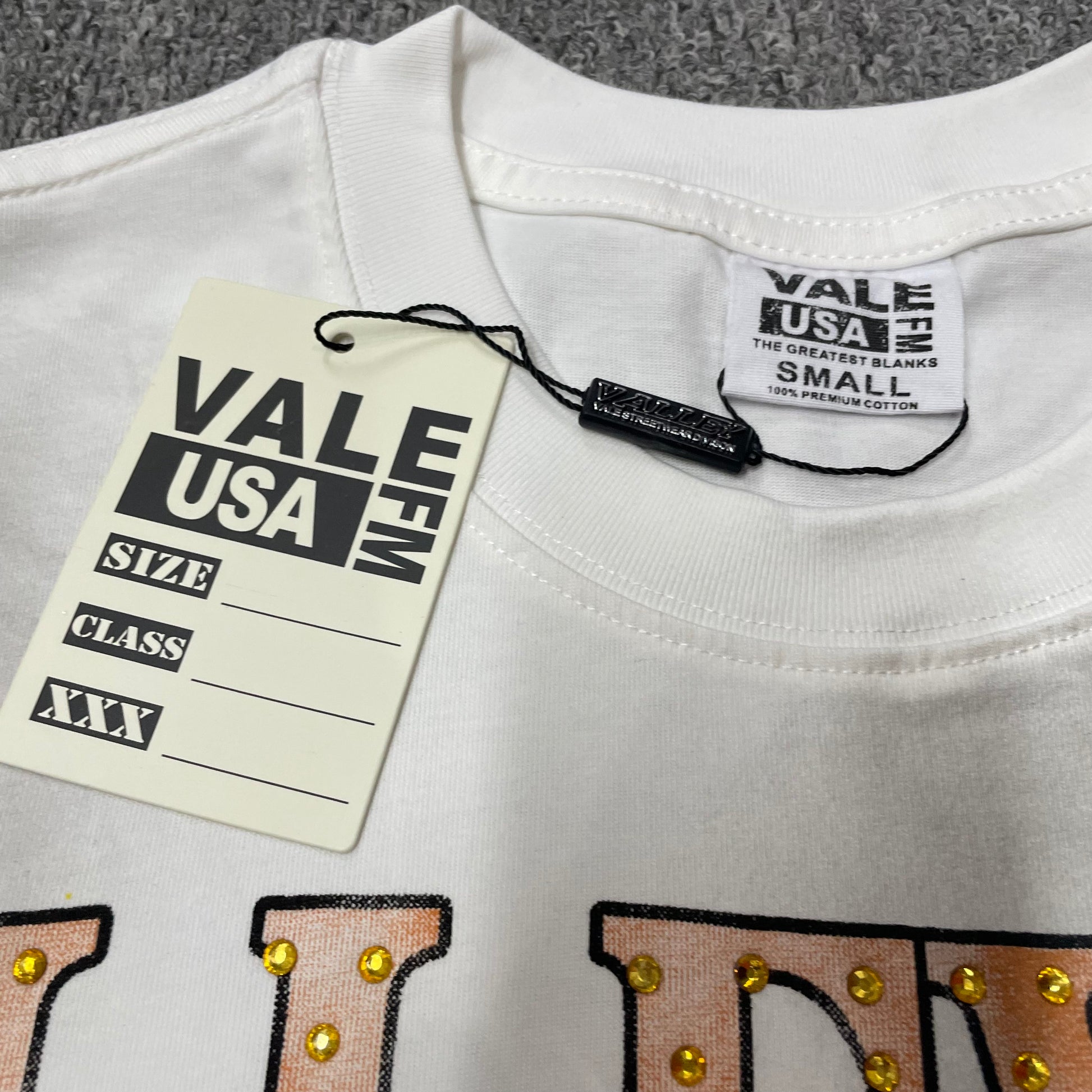 Vale Forever Thunder Cross Bling Tee crew neck stitching detail
Vale Forever Thunder Cross Bling Tee branded neck label close-up
Vale Forever Thunder Cross Bling Tee Dirt White size label detail
Vale Forever Thunder Cross Bling Tee branded hang tag detail