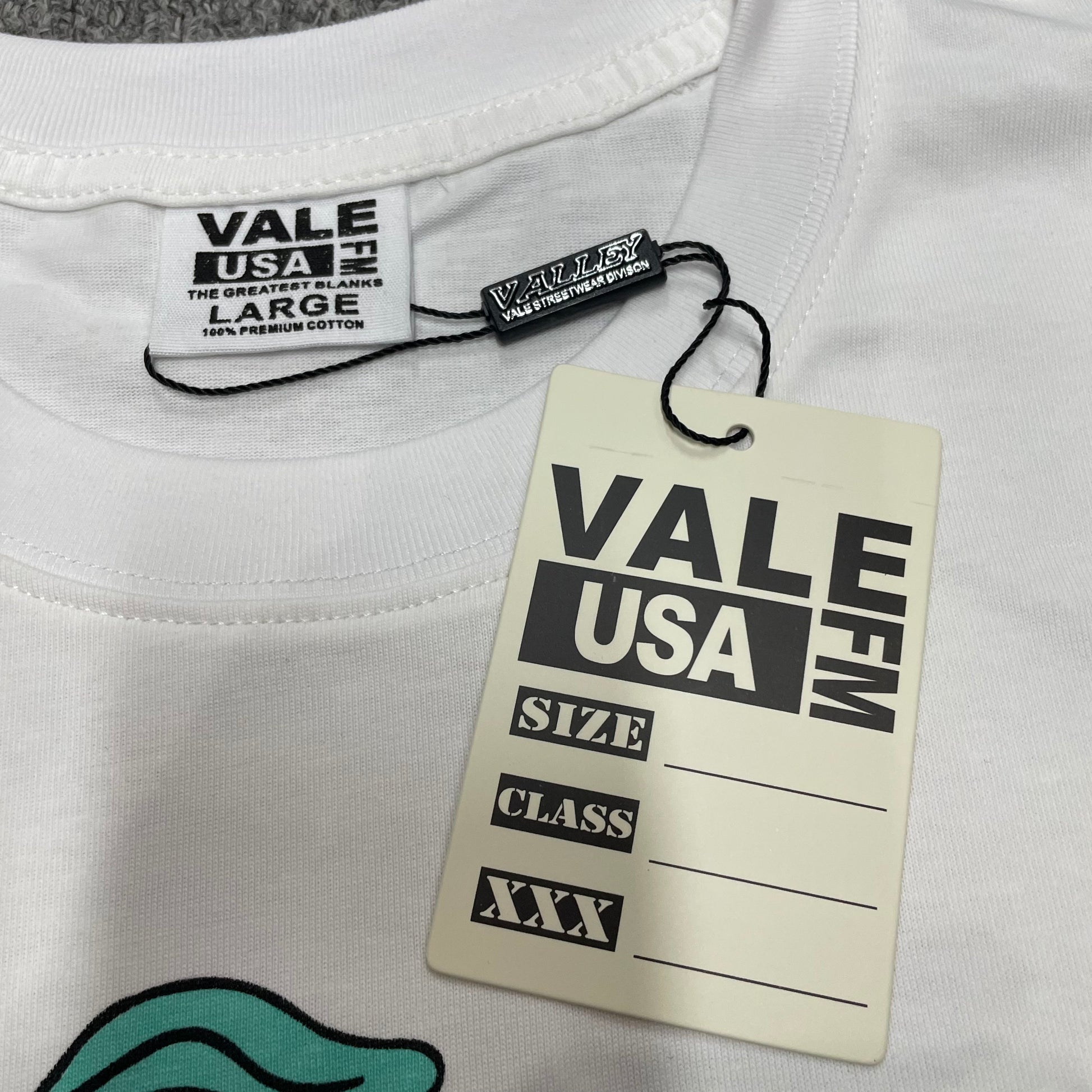 Vale Forever Valley Track Tee crew neck stitching detail
Vale Forever Valley Track Tee branded neck label close-up
Vale Forever Valley Track Wing Bling Tee size label detail
Vale Forever Valley Track Wing Bling Tee branded hang tag detail