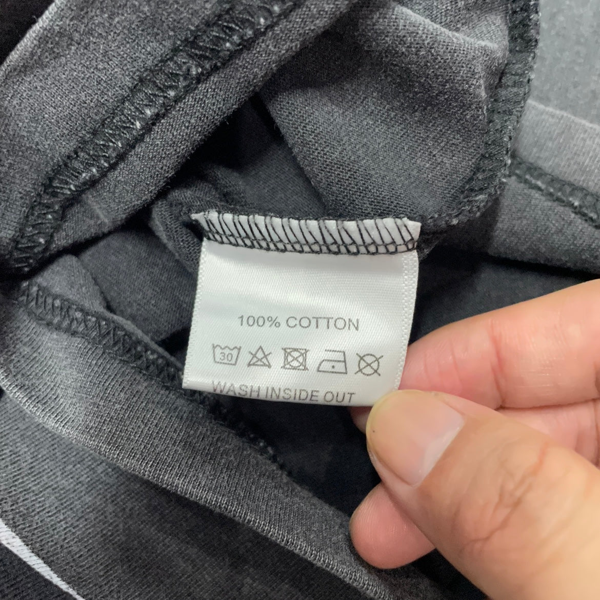 Vale Forever Heaven Boxer Tee double stitched bottom hem detail
Vale Forever Heaven Boxer Tee wash care label close-up
