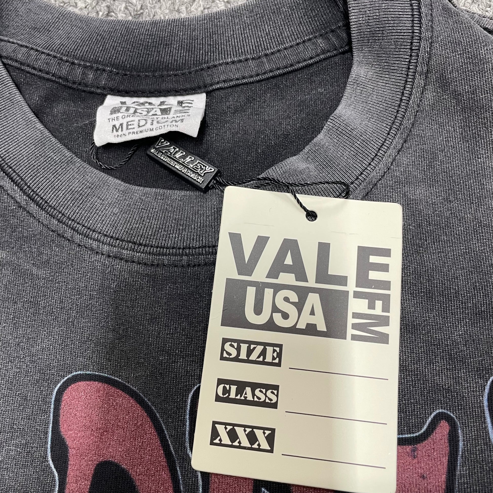 Vale Forever Marvins Dreams Tee crew neck stitching detail
Vale Forever Marvins Dreams Tee branded neck label close-up
Vale Forever Marvins Dreams Tee Black size label detail
Vale Forever Marvins Dreams Tee branded hang tag detail