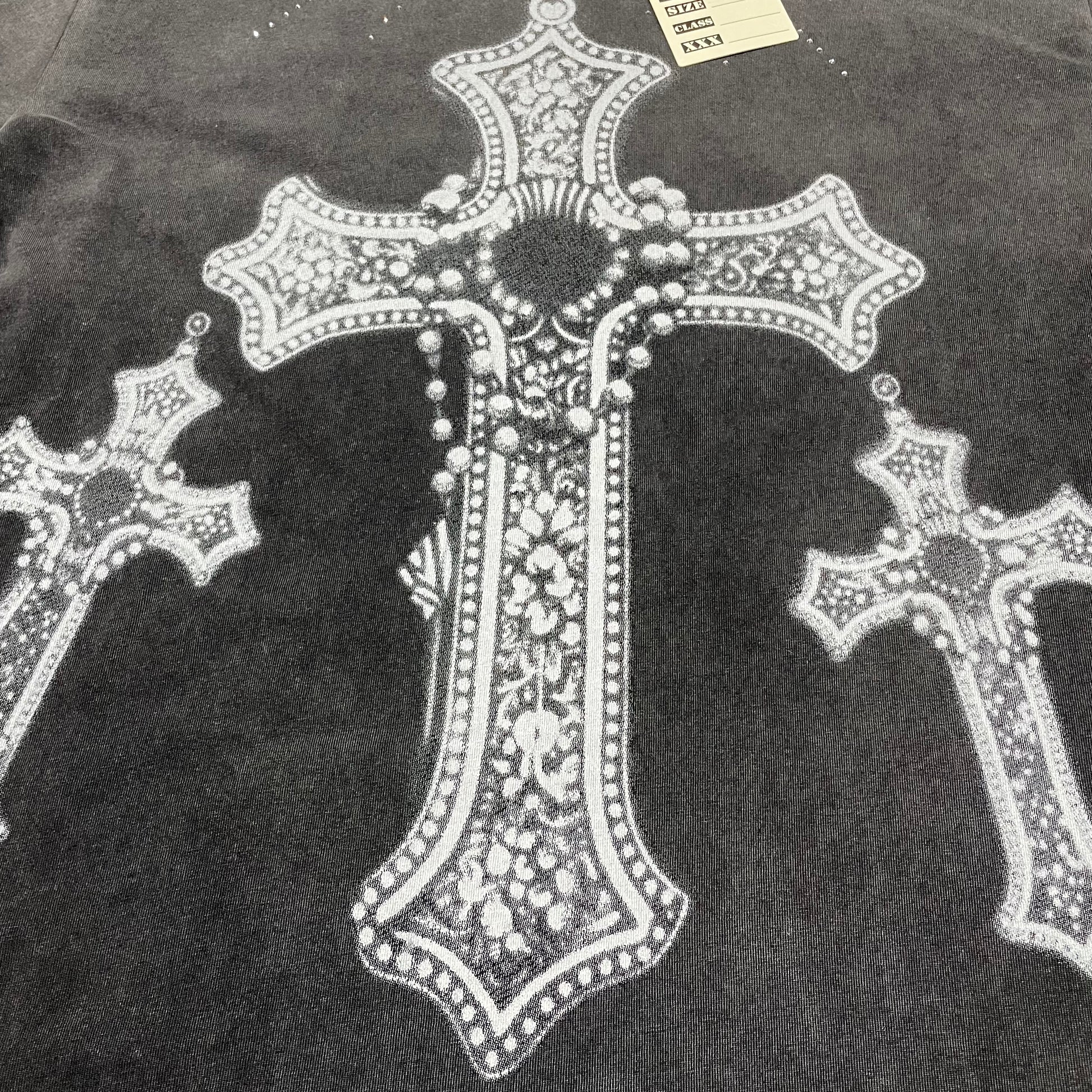 Vale Forever Iron Cross Bling Tee full jeweled cross front graphic
Vale Forever Iron Cross Bling Tee ornate jeweled cross artwork
Vale Forever Iron Cross Bling Tee detailed gothic cross graphic close-up
Vale Forever Iron Cross Bling Tee oversized center cross graphic detail
Vale Forever Iron Cross Bling Tee left jeweled cross print detail
Vale Forever Iron Cross Bling Tee right jeweled cross print detail
Vale Forever Iron Cross Bling Tee crystal cross embellishment close-up
Vale Forever Iron Cross Bling Tee