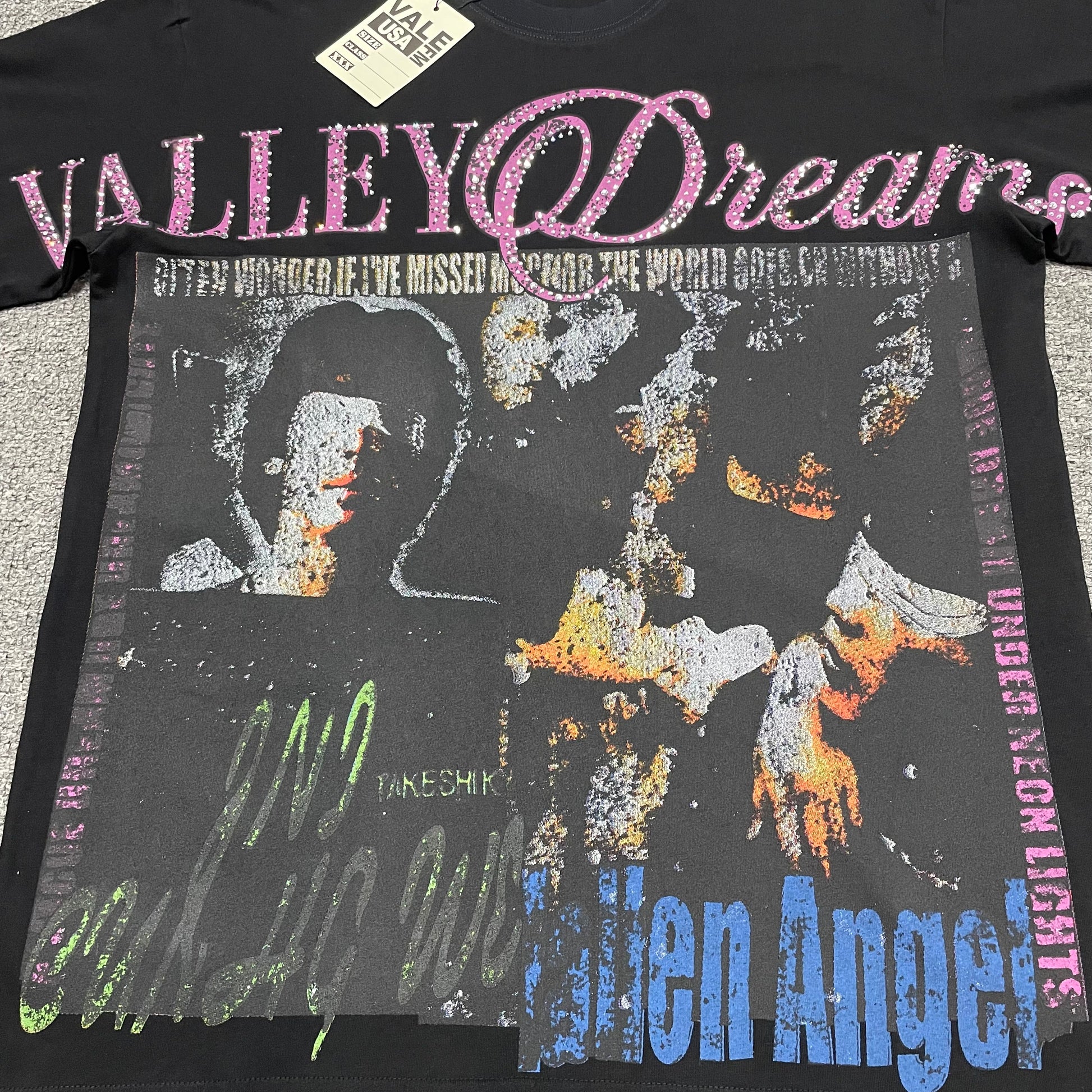 Vale Forever Fallen Bling Tee full Fallen Angel collage front graphic
Vale Forever Fallen Bling Tee distressed Fallen Angel collage artwork
Vale Forever Fallen Bling Tee distressed portrait collage print detail
Vale Forever Fallen Bling Tee pink crystal Valley Dreams lettering
Vale Forever Fallen Bling Tee pink rhinestone embellishment close-up
Vale Forever Fallen Bling Tee crystal Valley lettering detail
Vale Forever Fallen Bling Tee pink Dreams script lettering detail