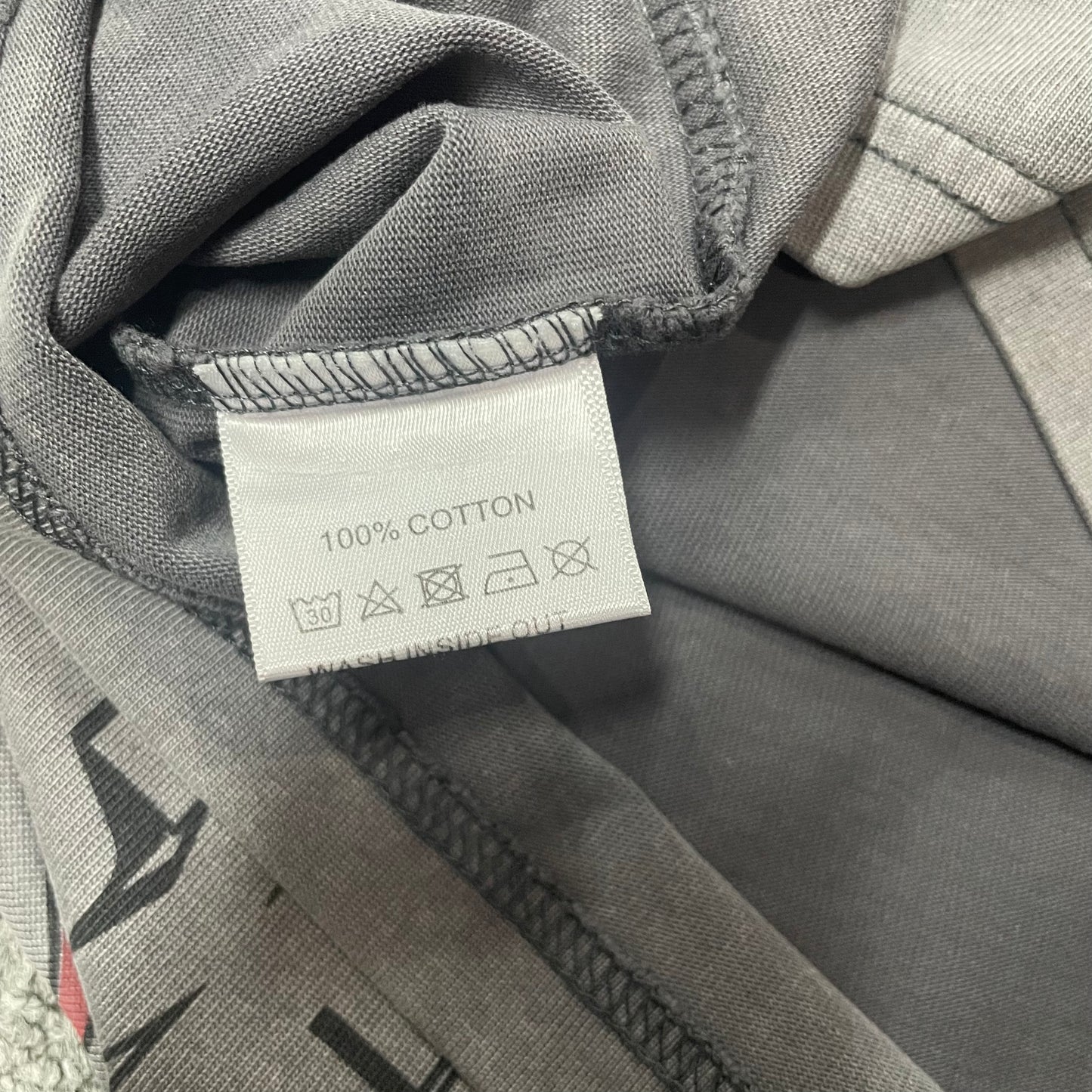 Vale Forever 199X Fest Tee double stitched bottom hem detail
Vale Forever 199X Fest Tee wash care label close-up
