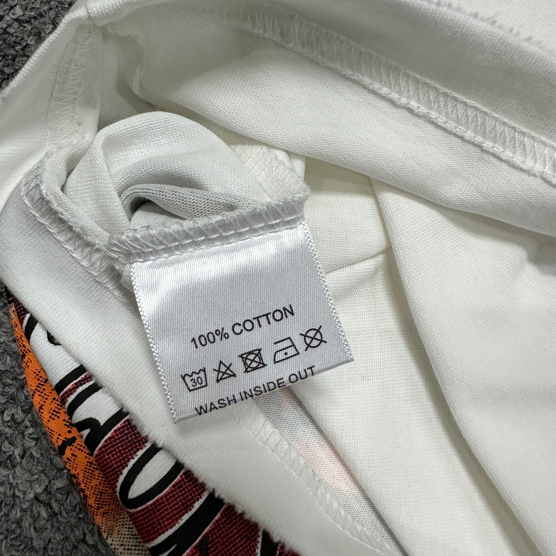 Vale Forever Dog of War Bling Tee double stitched bottom hem detail
Vale Forever Dog of War Bling Tee wash care label close-up