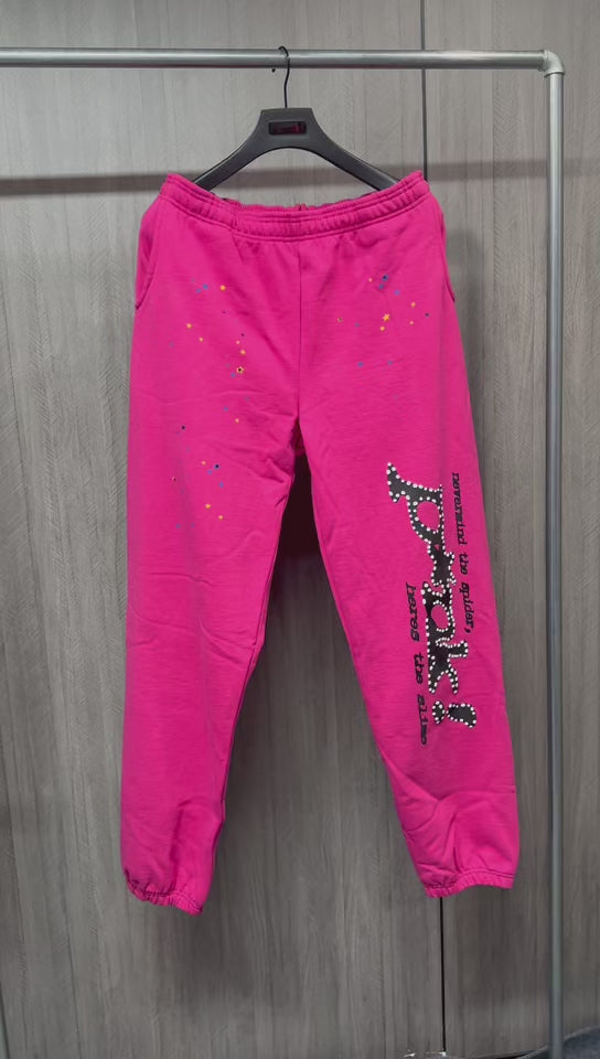 SP5DER P*NK V2 pink sweatpants front view with black leg graphic and multicolor stars