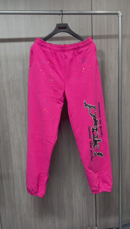 SP5DER P*NK V2 pink sweatpants front view with black leg graphic and multicolor stars