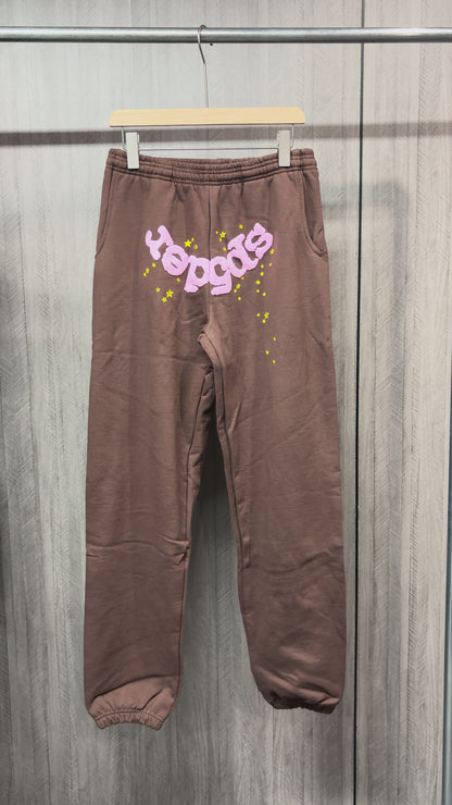 SP5DER Classic brown sweatpants front view with pink logo and yellow star graphics