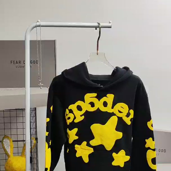 Sp5der Beluga Hoodie Onyx Yellow front view with raised yellow lettering and oversized star graphics