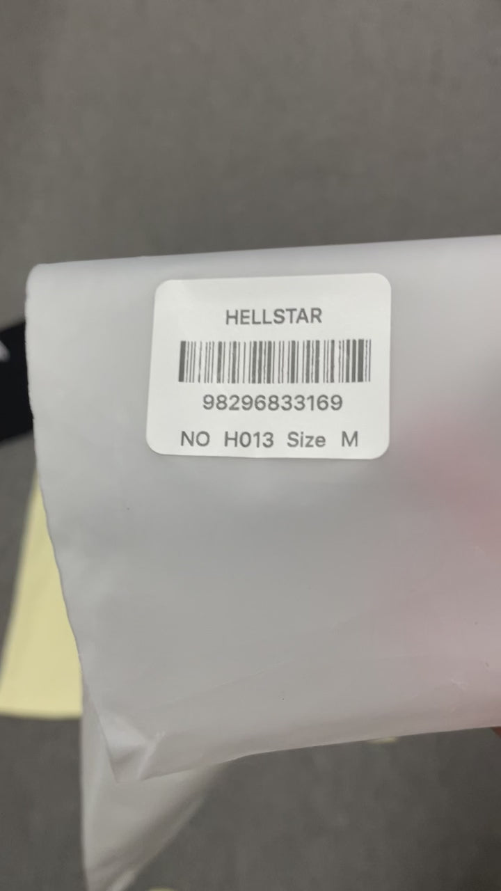 Hellstar Helmet Tee in Cream and Black front view with oversized helmeted face graphic
