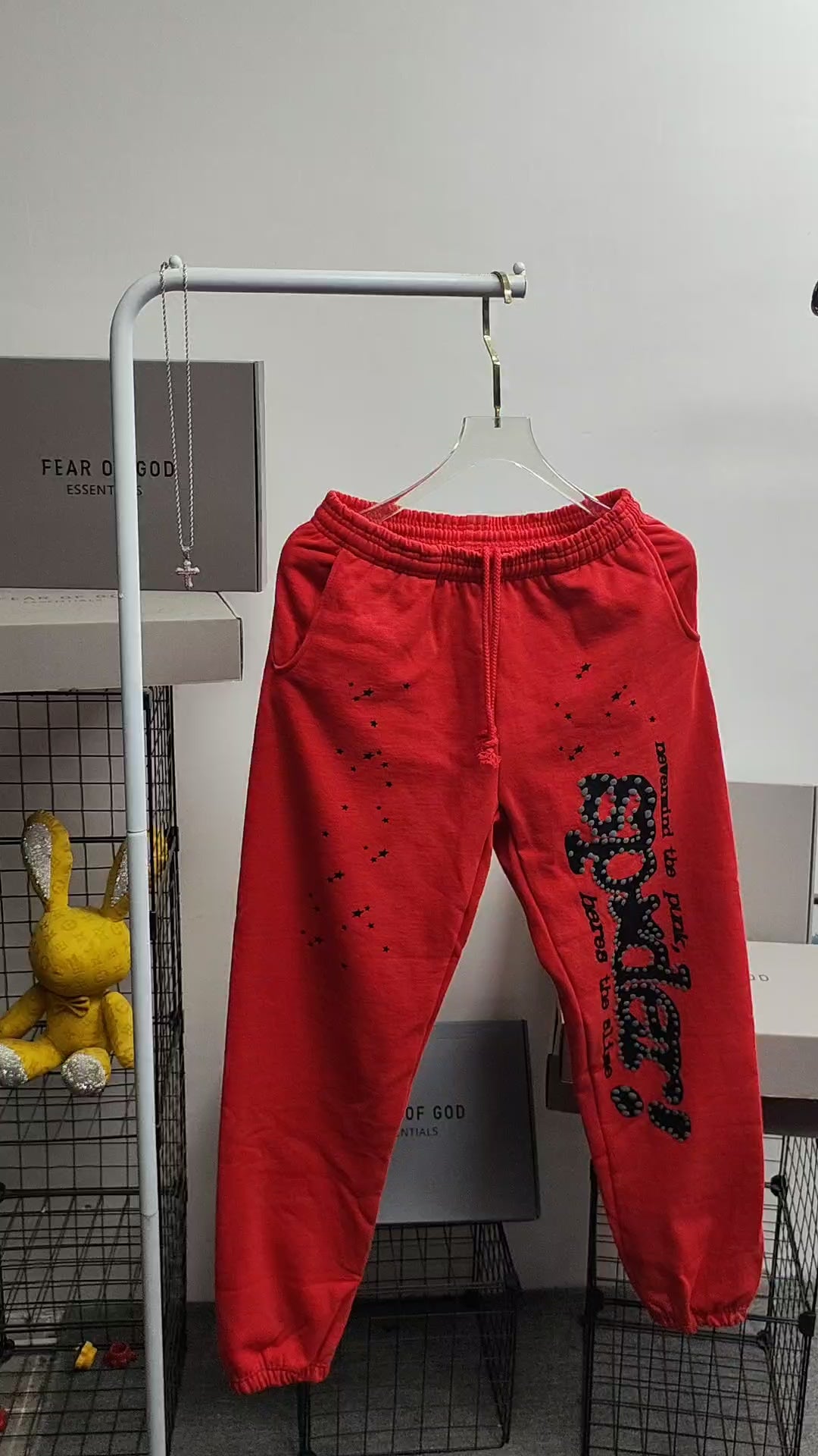 SP5DER P*NK V2 red sweatpants front view with black leg graphic and scattered stars