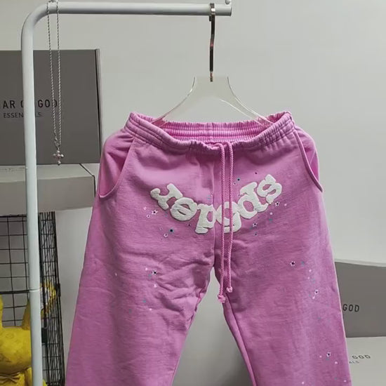 SP5DER Atlanta pink sweatpants front view with white logo and scattered star graphics