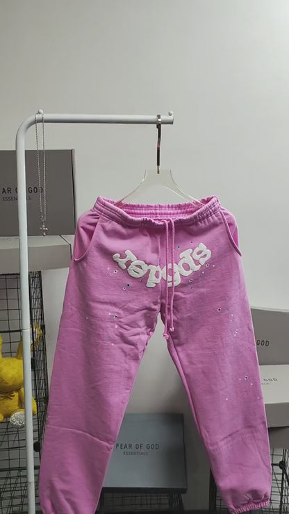 SP5DER Atlanta pink sweatpants front view with white logo and scattered star graphics