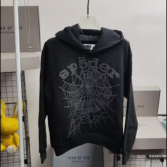 Sp5der OG Web Hoodie Black front view with raised dark-grey logo and tonal spider-web graphic