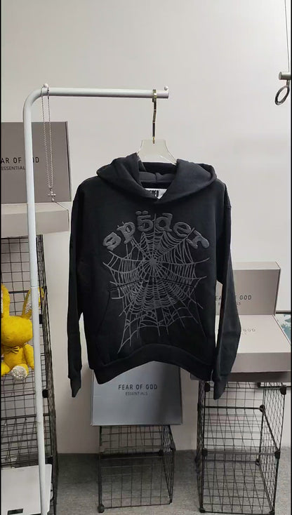 Sp5der OG Web Hoodie Black front view with raised dark-grey logo and tonal spider-web graphic